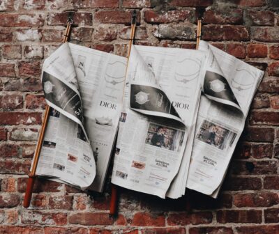 newspapers against brick wall